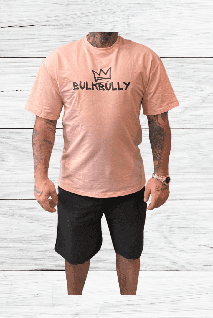 BulkBully G.O.A.L.S Collection Mens Oversized Tee in pink, styled with black shorts. Relaxed fit perfect for casual and athletic wear.