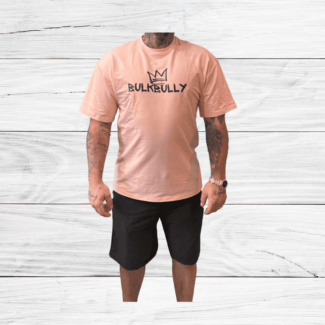BulkBully G.O.A.L.S Collection Mens Oversized Tee in pink, styled with black shorts. Relaxed fit perfect for casual and athletic wear.