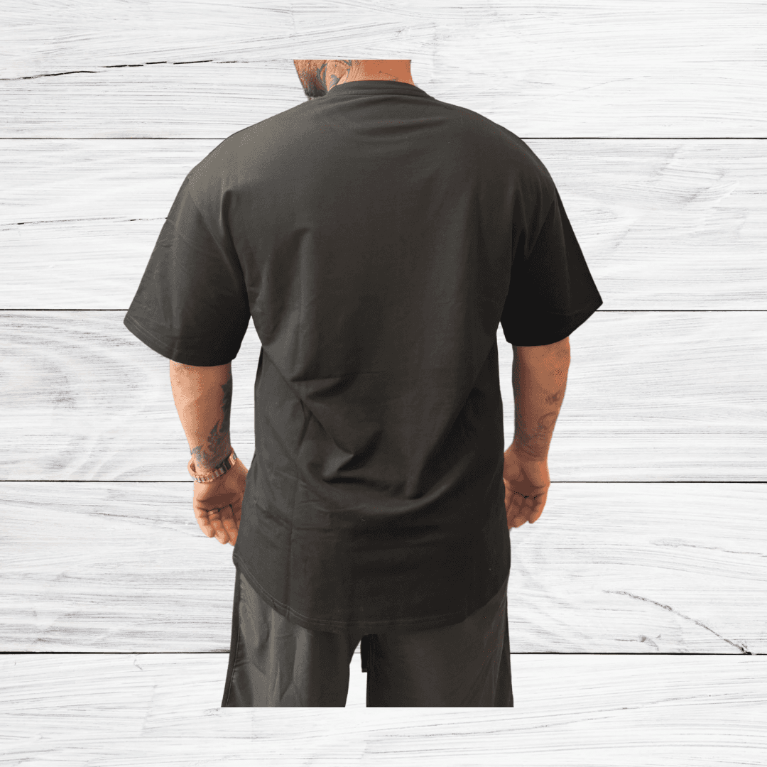 Back view of Mens Black Oversized Tee from BulkBullys G.O.A.L.S Collection showing extended length and loose fit ideal for casual wear.