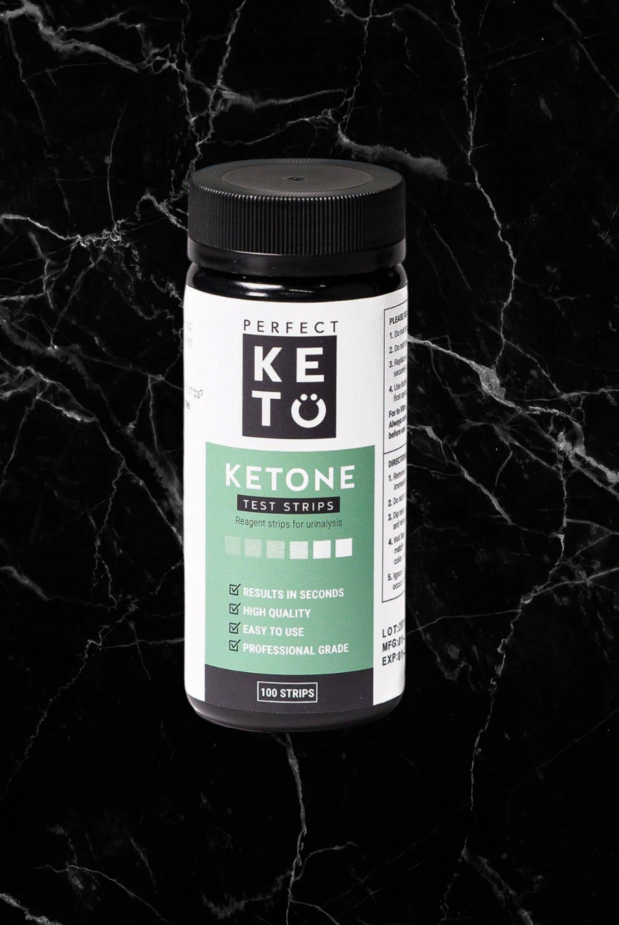 Perfect Keto Ketone Test Strips bottle on black marble background. Quick, easy test to measure keto progress and acetoacetate levels.