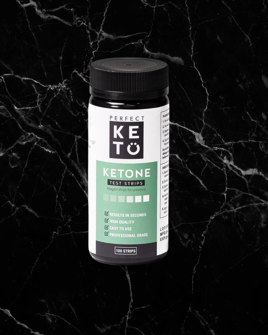 Perfect Keto Ketone Test Strips bottle on black marble background. Quick, easy test to measure keto progress and acetoacetate levels.