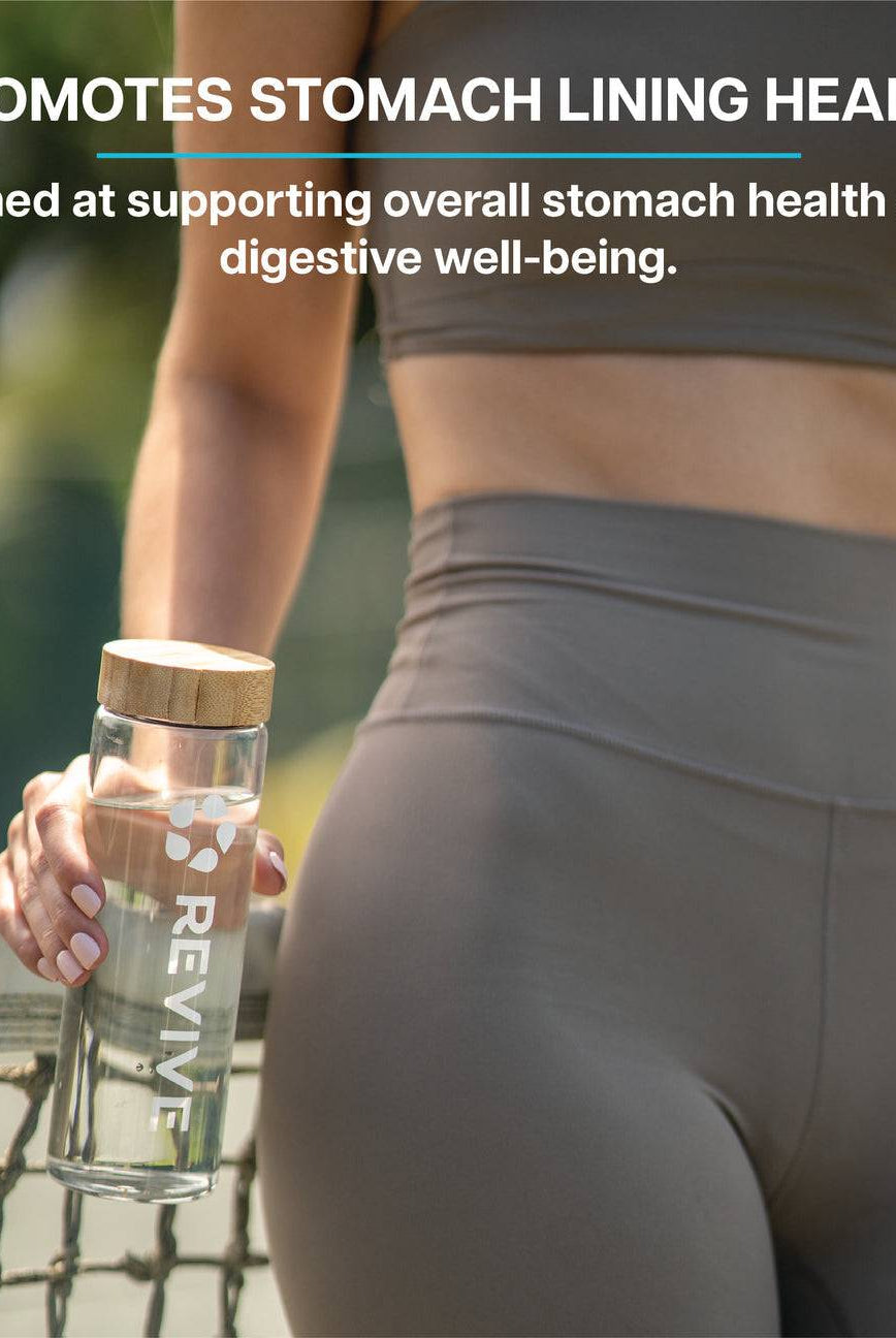 Active woman holding a Revive water bottle, emphasizing Revive Zinc Carnosine's support for stomach lining and digestive well-being.