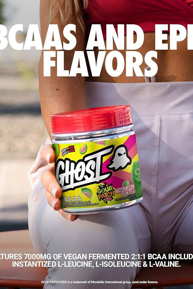 Close-up of GHOST BCAAs Sour Patch Kids Watermelon tub with text highlighting 7000mg of vegan fermented BCAAs and epic flavors.