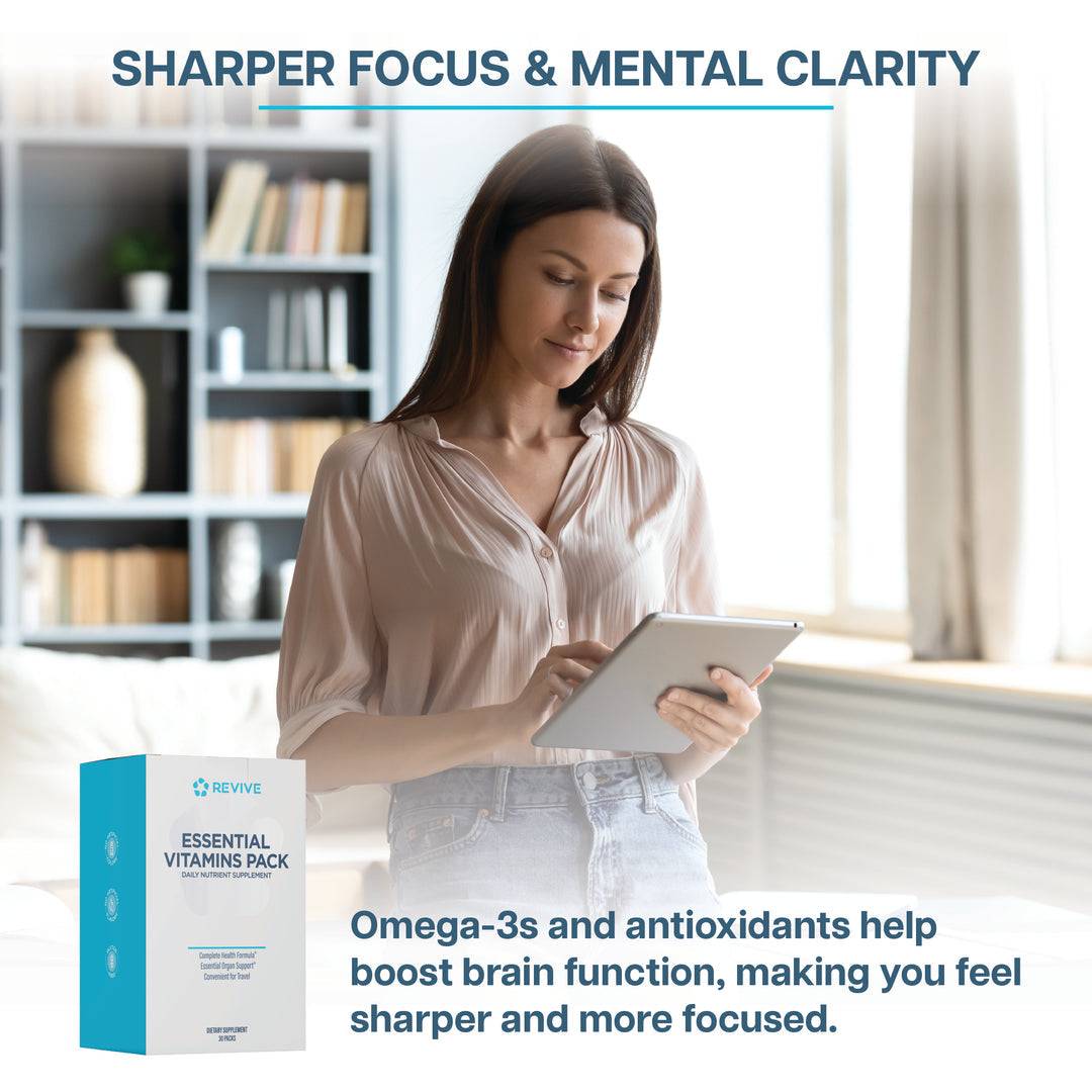 Woman using a tablet with Revive Vitamin Pack box shown, promoting mental clarity and sharper focus from omega-3s and antioxidants.