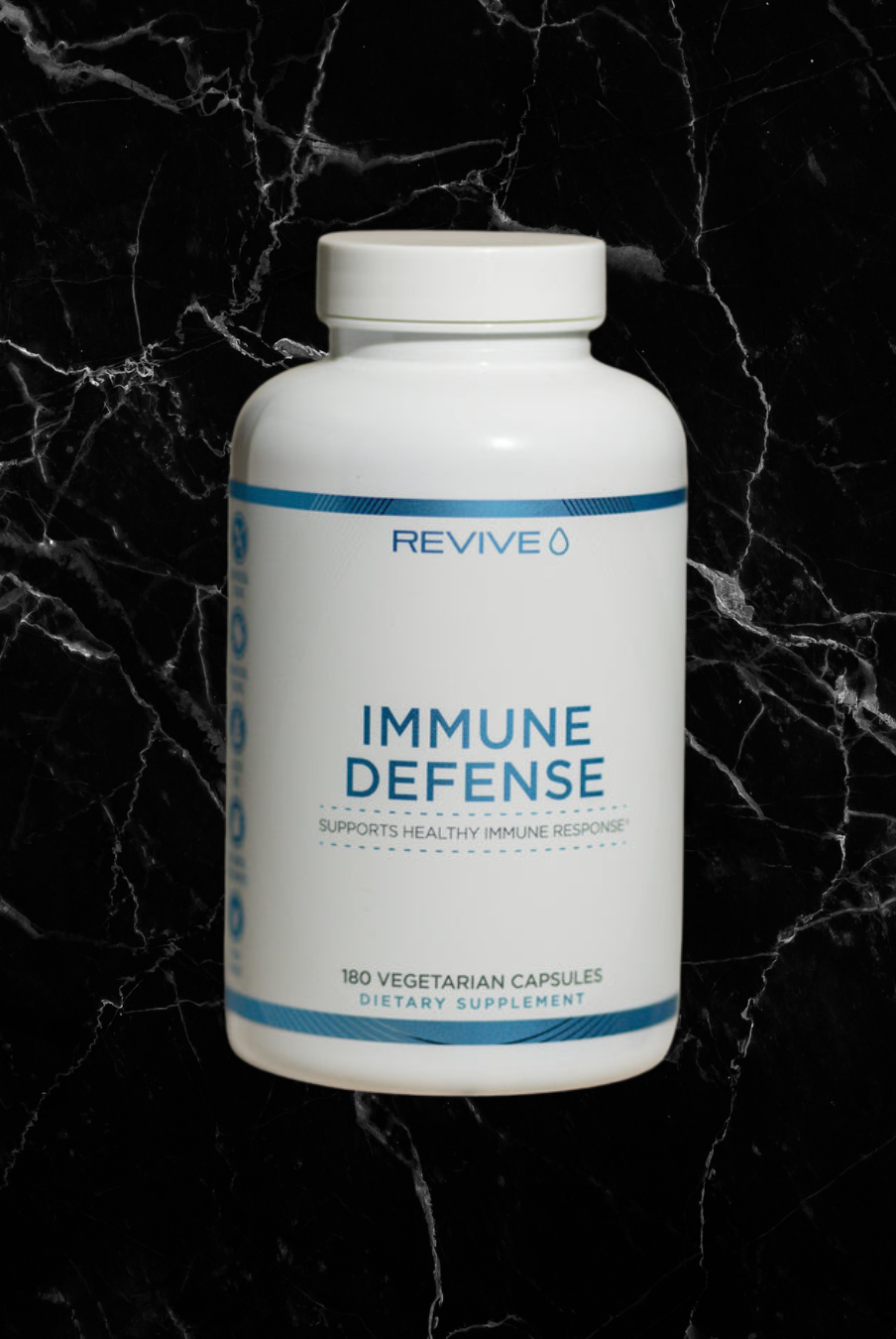 REVIVE Immune Defense Booster bottle with 180 vegetarian capsules, designed to support immune health with natural ingredients like Zinc and Vitamin C.