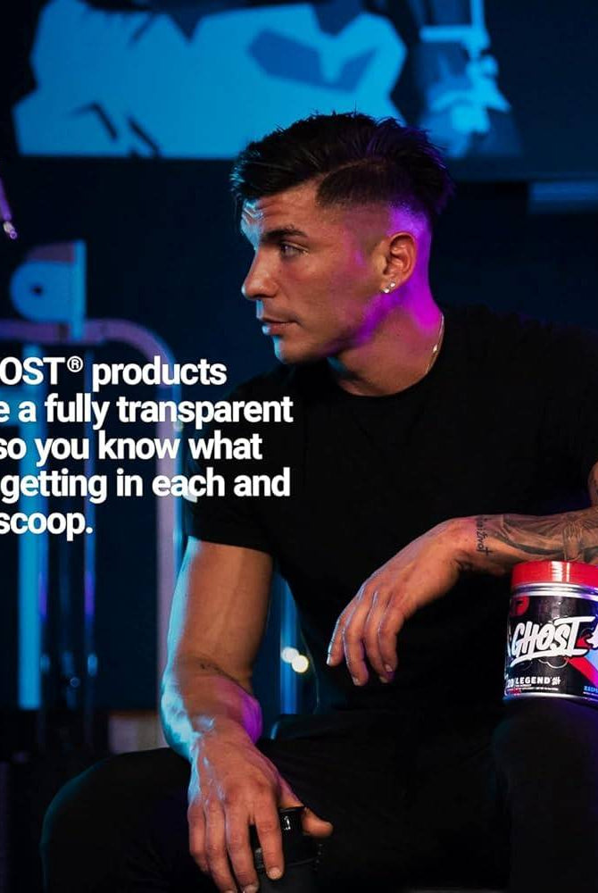 Man seated in gym holding Ghost Legend All Out Pre Workout. Emphasizes fully transparent label for ingredient clarity and trust in fitness supplements.