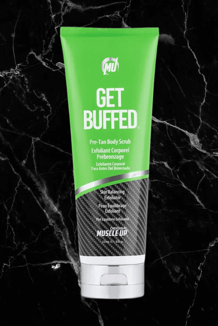 Get Buffed Pre-Tan Scrub by Pro Tan in green tube packaging on black marble background. Natural exfoliator for smooth, tan-ready skin.