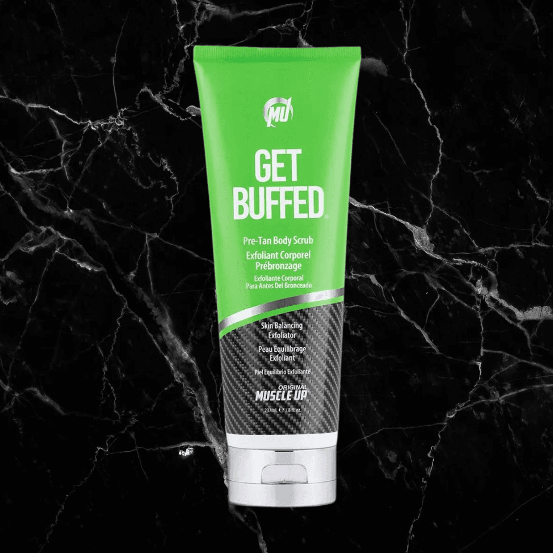 Get Buffed Pre-Tan Scrub by Pro Tan in green tube packaging on black marble background. Natural exfoliator for smooth, tan-ready skin.