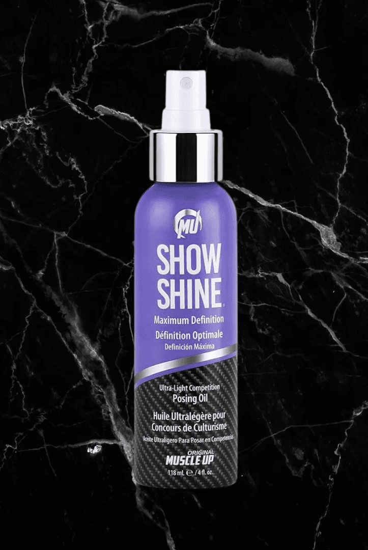 Pro Tan Show Shine Competition Posing Oil Spray in a sleek purple and black bottle, ideal for enhancing muscle definition and skin sheen.