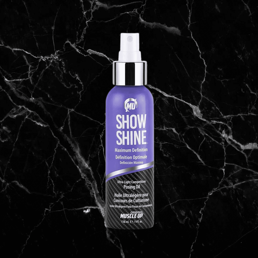 Pro Tan Show Shine Competition Posing Oil Spray in a sleek purple and black bottle, ideal for enhancing muscle definition and skin sheen.