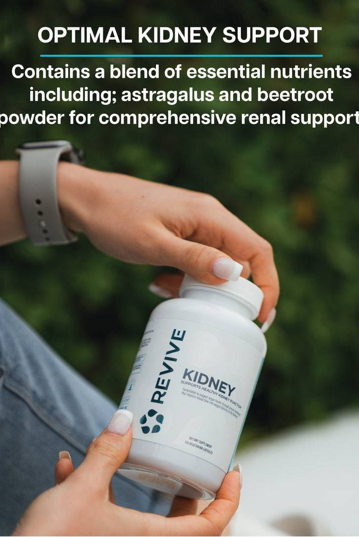 Person holding Revive Kidney Supplement bottle outdoors. Contains astragalus and beetroot for comprehensive kidney and renal health support.