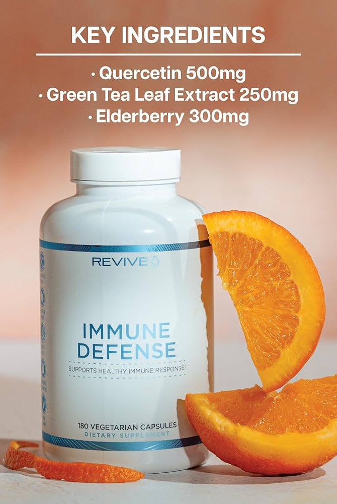 REVIVE Immune Defense Booster bottle with orange slices, showcasing key ingredients like Quercetin, Green Tea Leaf Extract, and Elderberry for immunity.