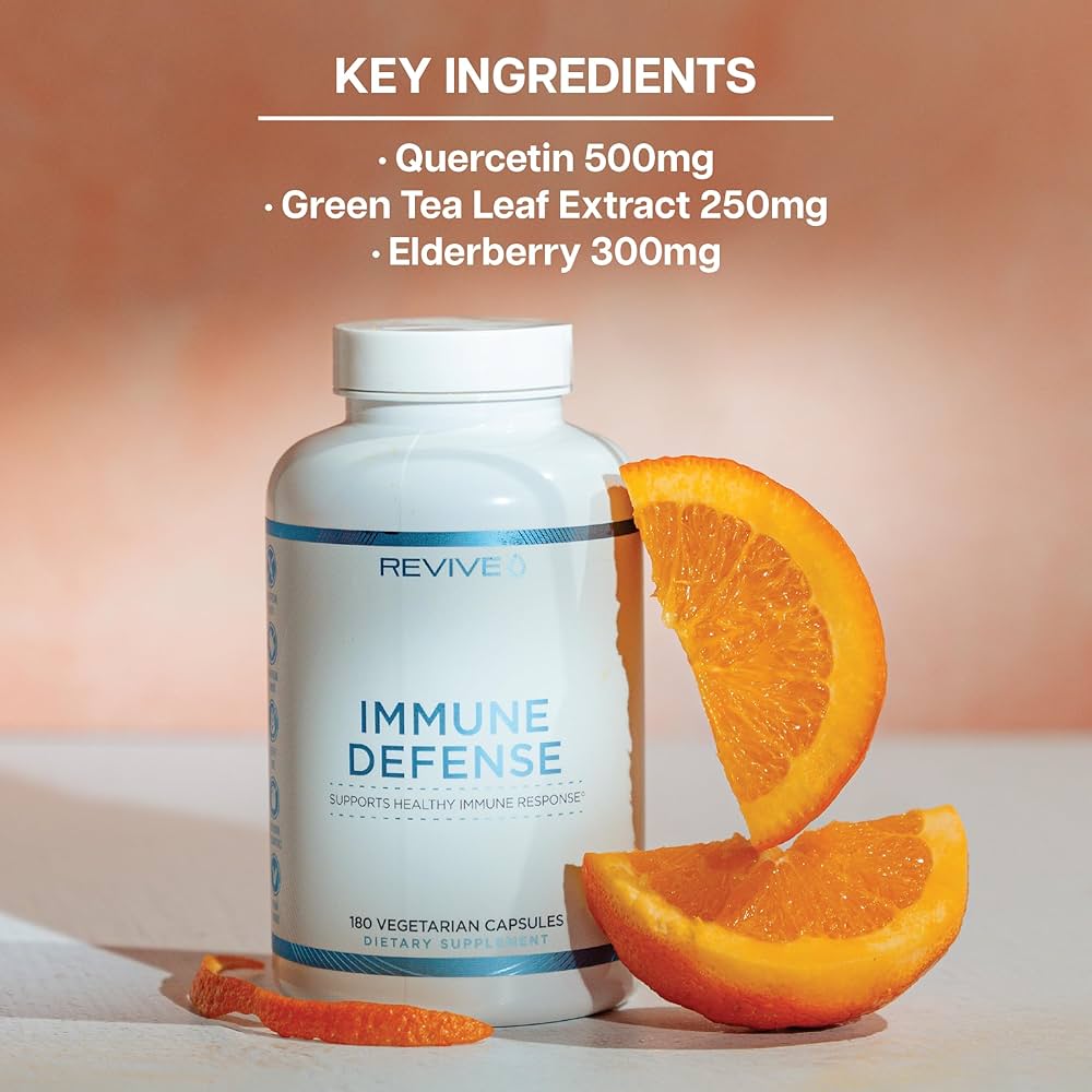 REVIVE Immune Defense Booster bottle with orange slices, showcasing key ingredients like Quercetin, Green Tea Leaf Extract, and Elderberry for immunity.