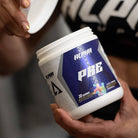 Person holding Alpha Supps Candied Tart Pre-Workout, showcasing product label and branding for energy and focus support.